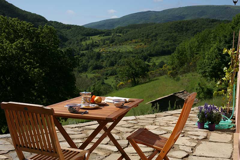 Table on chairs on the terrace over looking the hills