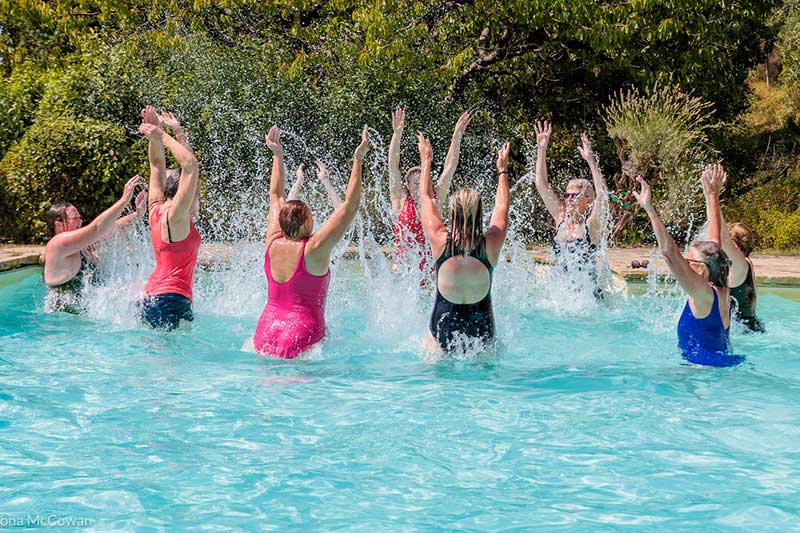 A group taking part in a pilates session in the pool